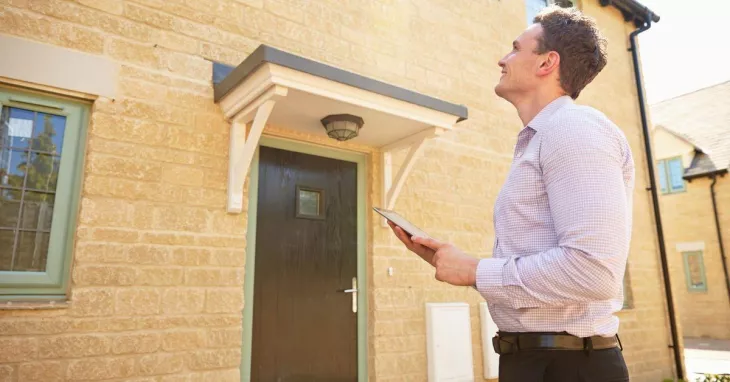 Property Surveyor making a survey to the roof and exteriors of the house