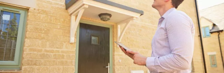 Property Surveyor making a survey to the roof and exteriors of the house