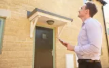Property Surveyor making a survey to the roof and exteriors of the house